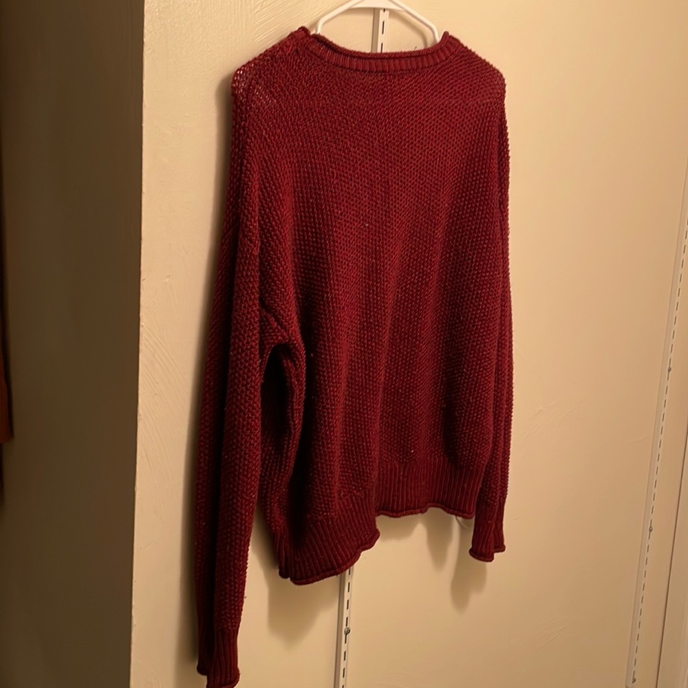 Lengthy maroon knitted sweater